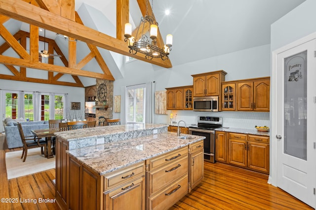 4225 Pleasant Glen Dr, Louisville, KY 40299 - kitchen with stainless steel appliances, high vaulted ceiling, a sink, open floor plan, and a chandelier