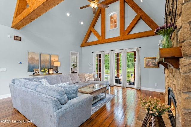 4225 Pleasant Glen Dr, Louisville, KY 40299 - living area featuring high vaulted ceiling, baseboards, a ceiling fan, a stone fireplace, and hardwood / wood-style flooring