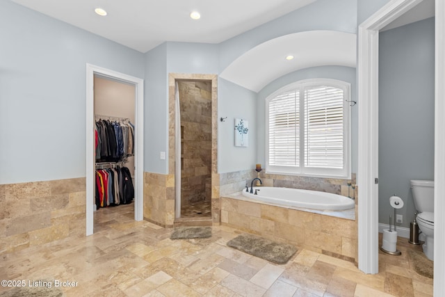 4225 Pleasant Glen Dr, Louisville, KY 40299 - bathroom featuring a bath, toilet, stone tile flooring, a tile shower, and a walk in closet