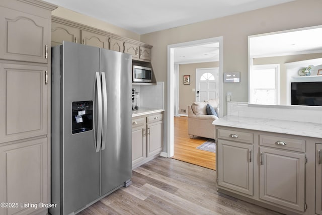 7408 Floydsburg Rd, Crestwood, KY 40014 - kitchen with appliances with stainless steel finishes, light wood-style floors, backsplash, gray cabinets, and ornamental molding