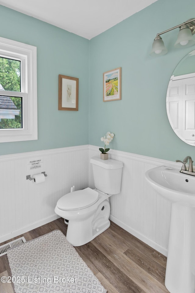 7408 Floydsburg Rd, Crestwood, KY 40014 - half bathroom featuring toilet, wainscoting, wood finished floors, and a sink