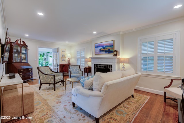 2417 Meadow Rd, Seneca Gardens, KY 40205 - living area featuring light wood finished floors, recessed lighting, a tile fireplace, crown molding, and baseboards