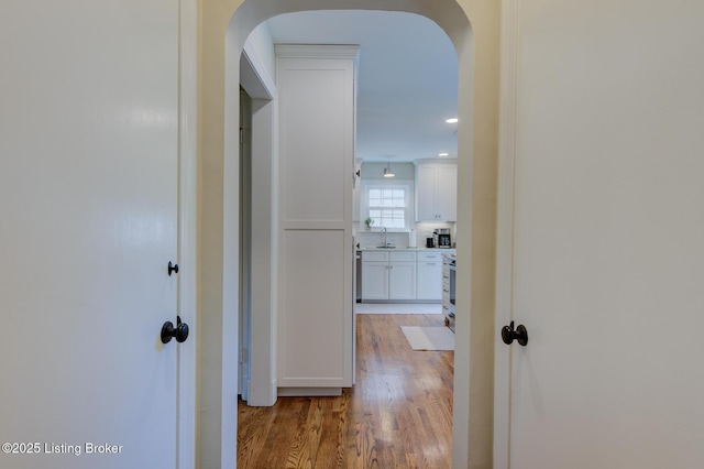 2417 Meadow Rd, Seneca Gardens, KY 40205 - hall featuring arched walkways, light wood-type flooring, a sink, and recessed lighting