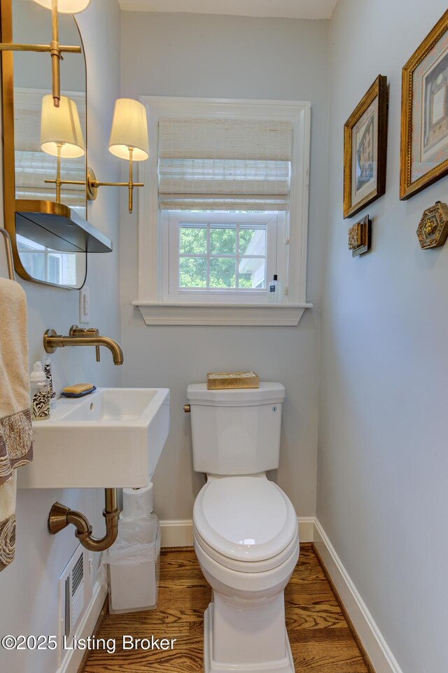 2417 Meadow Rd, Seneca Gardens, KY 40205 - half bath with wood finished floors, baseboards, and toilet