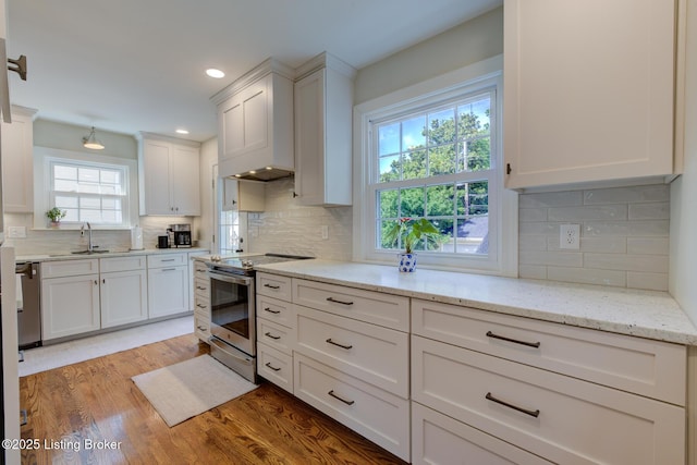 2417 Meadow Rd, Seneca Gardens, KY 40205 - kitchen with appliances with stainless steel finishes, a sink, white cabinetry, decorative backsplash, and light wood-style flooring