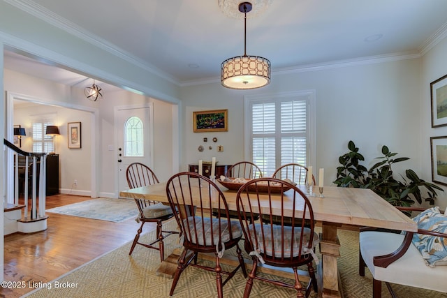 2417 Meadow Rd, Seneca Gardens, KY 40205 - dining space with wood finished floors, stairs, crown molding, and baseboards
