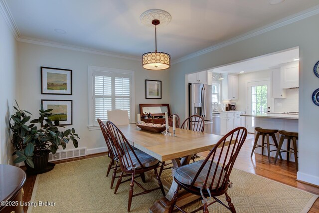 2417 Meadow Rd, Seneca Gardens, KY 40205 - dining room with wood finished floors, ornamental molding, and baseboards