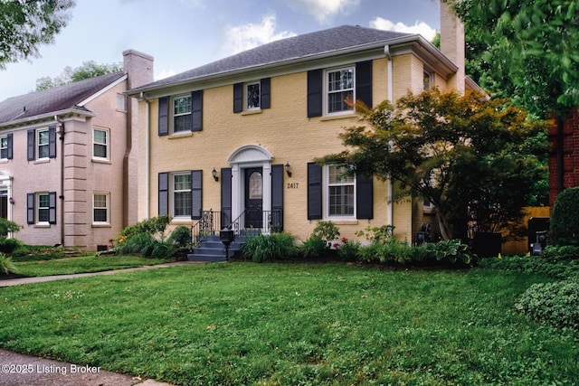 2417 Meadow Rd, Seneca Gardens, KY 40205 - view of front of home with a chimney, a front lawn, and brick siding