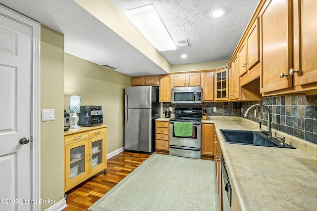 111 Emory Ct, Bardstown, KY 40004 - kitchen featuring stainless steel appliances, a sink, dark wood finished floors, light countertops, and backsplash