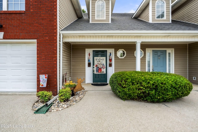 111 Emory Ct, Bardstown, KY 40004 - view of exterior entry featuring a shingled roof, a garage, brick siding, and a porch