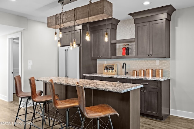 5404 River Creek Ct, Prospect, KY 40059 - kitchen featuring freestanding refrigerator, wood finished floors, backsplash, dark brown cabinetry, and recessed lighting