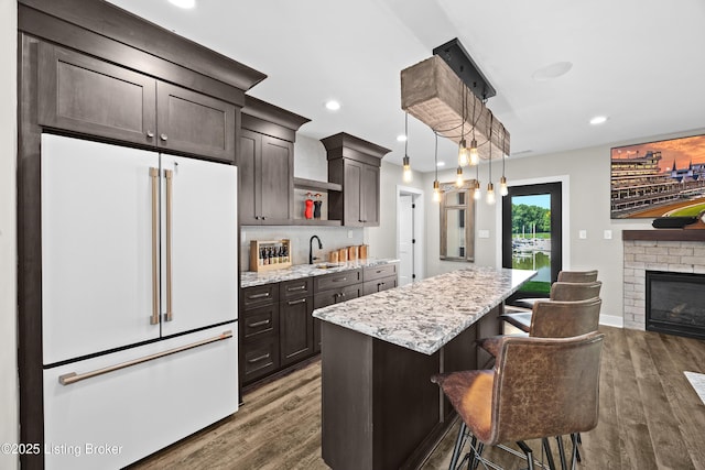 5404 River Creek Ct, Prospect, KY 40059 - kitchen featuring white refrigerator, a kitchen island, dark wood-style flooring, a kitchen breakfast bar, and recessed lighting