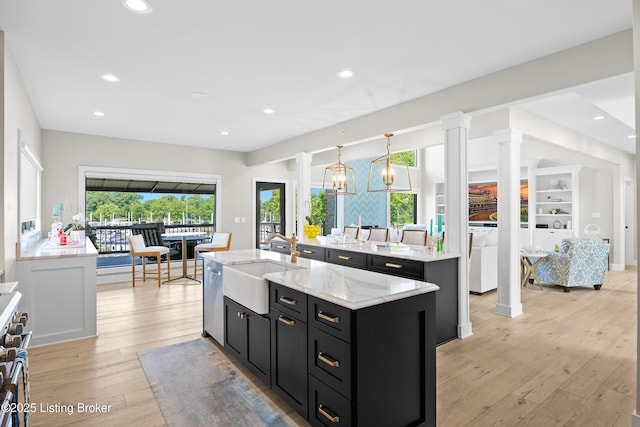 5404 River Creek Ct, Prospect, KY 40059 - kitchen featuring dark cabinetry, a center island with sink, appliances with stainless steel finishes, light wood-type flooring, and recessed lighting