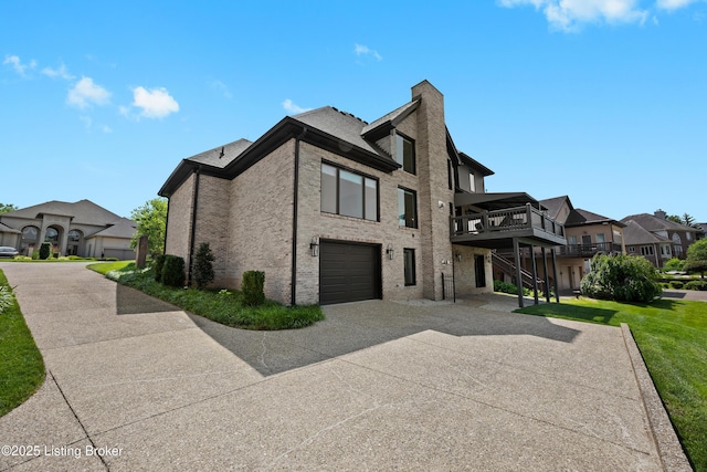 5404 River Creek Ct, Prospect, KY 40059 - view of side of home with concrete driveway, a chimney, an attached garage, a deck, and brick siding