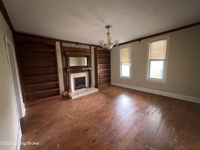 1535 Bardstown Rd, Hodgenville, KY 42748 - unfurnished living room featuring ornamental molding, a chandelier, baseboards, wood-type flooring, and a fireplace with raised hearth
