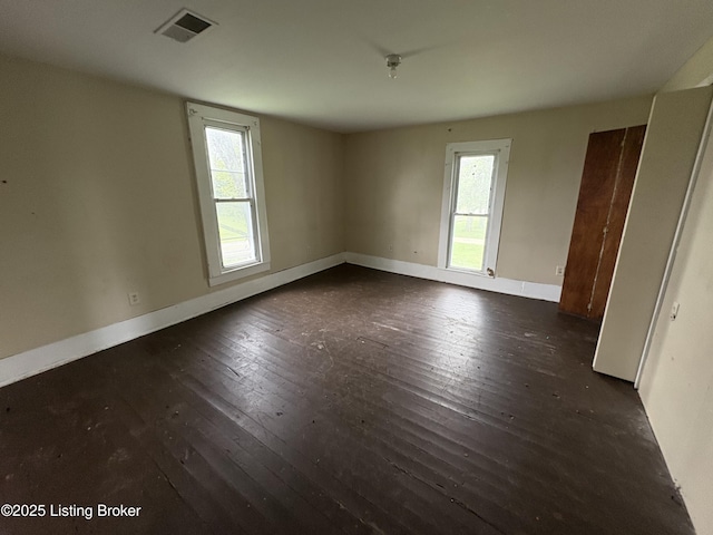 1535 Bardstown Rd, Hodgenville, KY 42748 - empty room with dark wood-style flooring, plenty of natural light, and baseboards