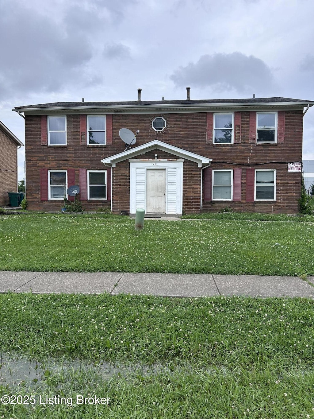 7415 Garrison Rd, Louisville, KY 40214 - view of front of home with a front yard and brick siding