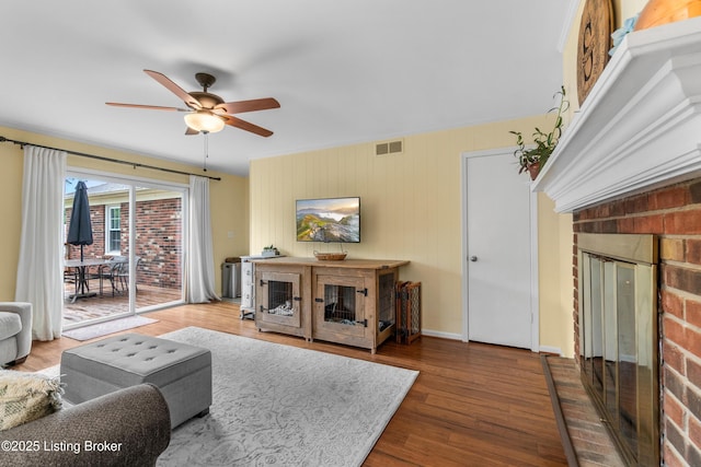 7401 Maria Ave, Louisville, KY 40222 - living area with a fireplace, a ceiling fan, wood finished floors, and crown molding