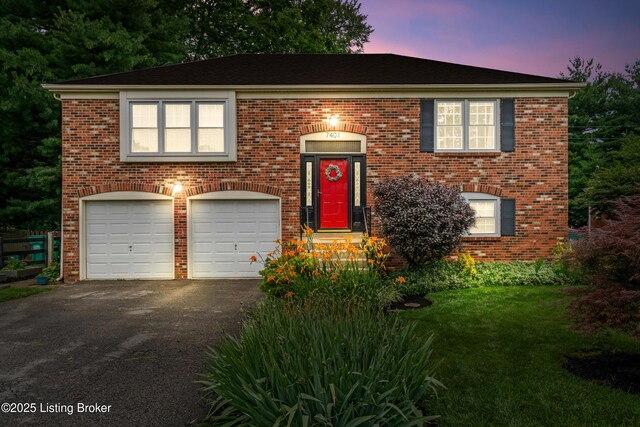 7401 Maria Ave, Louisville, KY 40222 - raised ranch with an attached garage, driveway, and brick siding