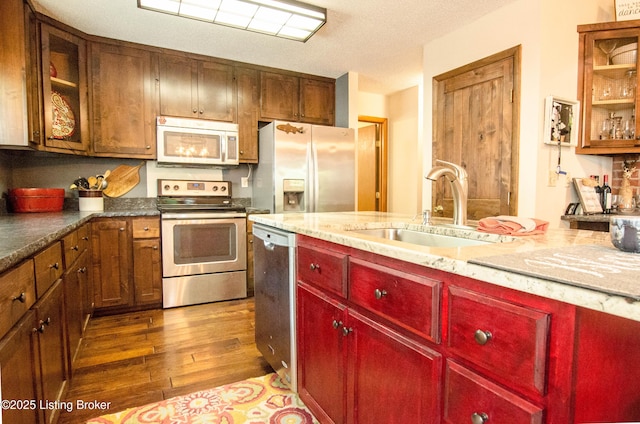 52 Lakeshore Cir, Leitchfield, KY 42754 - kitchen featuring appliances with stainless steel finishes, dark wood-style flooring, dark brown cabinets, and light stone countertops