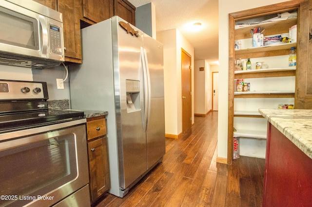 52 Lakeshore Cir, Leitchfield, KY 42754 - kitchen featuring stainless steel appliances, dark wood finished floors, brown cabinetry, and light stone counters