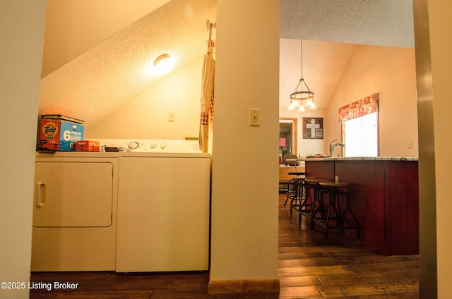 52 Lakeshore Cir, Leitchfield, KY 42754 - laundry area with washing machine and clothes dryer, a textured ceiling, dark wood-style flooring, and a chandelier