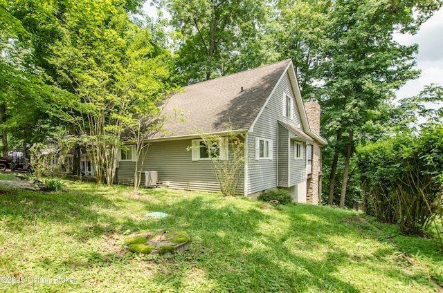 52 Lakeshore Cir, Leitchfield, KY 42754 - view of side of property with a chimney, a shingled roof, and a lawn