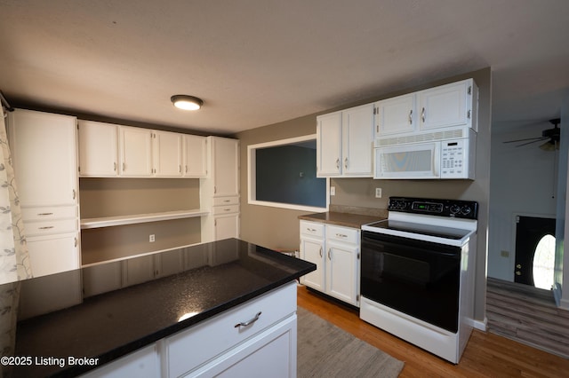 7215 Applegate Ln, Louisville, KY 40228 - kitchen featuring white microwave, range with electric stovetop, dark countertops, dark wood-style floors, and white cabinetry