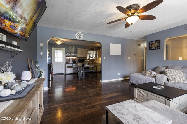 1108 Palisades Dr, Frankfort, KY 40601 - living room with arched walkways, a ceiling fan, dark wood-style floors, and a textured ceiling