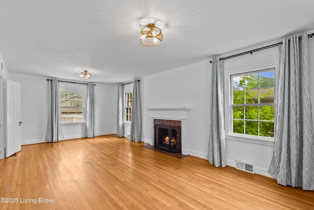 213 Barberry Ln, Lexington, KY 40503 - unfurnished living room featuring a fireplace, plenty of natural light, and light wood-type flooring