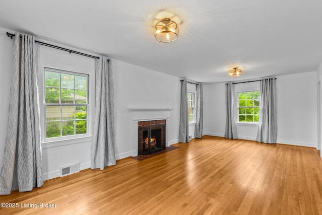 213 Barberry Ln, Lexington, KY 40503 - unfurnished living room featuring light wood-type flooring, a brick fireplace, and baseboards