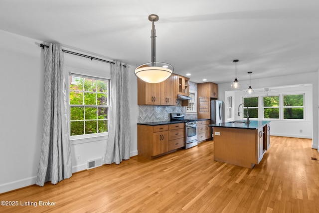 213 Barberry Ln, Lexington, KY 40503 - kitchen with appliances with stainless steel finishes, brown cabinetry, a sink, dark countertops, and baseboards