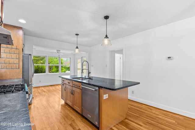 213 Barberry Ln, Lexington, KY 40503 - kitchen featuring appliances with stainless steel finishes, light wood-style floors, a kitchen island with sink, and decorative light fixtures