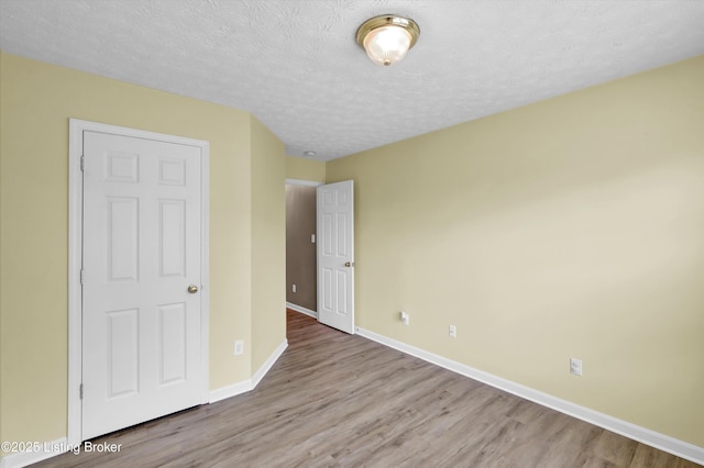 8405 Adams Run Rd, Louisville, KY 40228 - unfurnished bedroom featuring wood finished floors, baseboards, and a textured ceiling