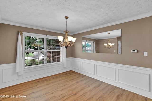 8405 Adams Run Rd, Louisville, KY 40228 - unfurnished dining area with a chandelier, light wood-style flooring, wainscoting, a textured ceiling, and crown molding
