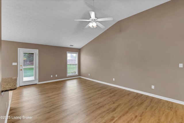 8405 Adams Run Rd, Louisville, KY 40228 - spare room with light wood-type flooring, vaulted ceiling, a ceiling fan, and baseboards