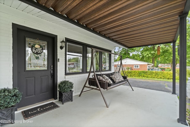 1709 Wickham Way, Louisville, KY 40223 - doorway to property with concrete block siding and covered porch