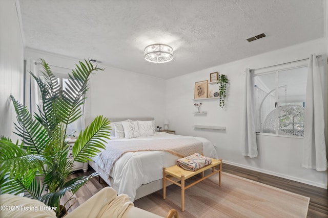 1709 Wickham Way, Louisville, KY 40223 - bedroom featuring a textured ceiling, wood finished floors, baseboards, and a chandelier