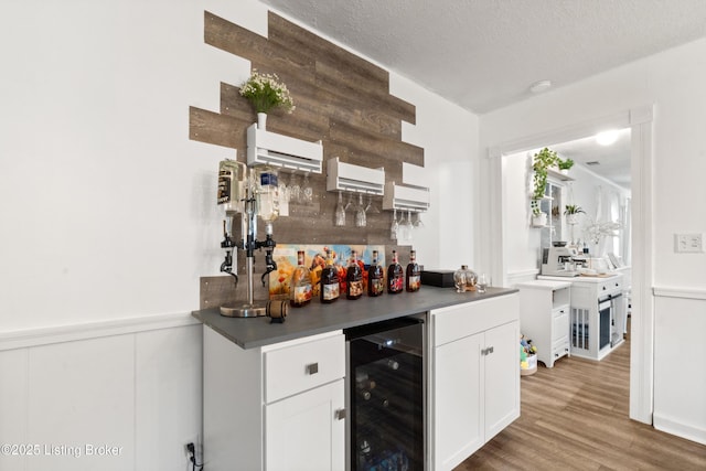 1709 Wickham Way, Louisville, KY 40223 - indoor bar with wine cooler, wood finished floors, wainscoting, a textured ceiling, and a wall unit AC