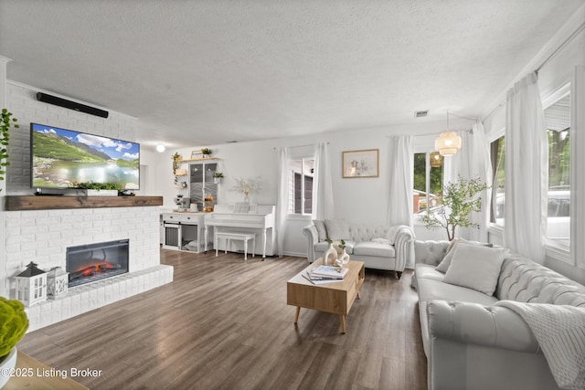 1709 Wickham Way, Louisville, KY 40223 - living room featuring a textured ceiling, wood finished floors, and a brick fireplace