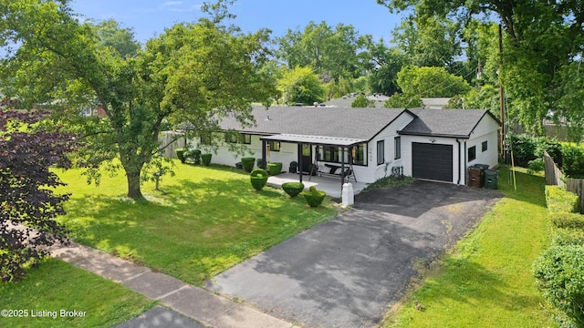 1709 Wickham Way, Louisville, KY 40223 - view of front facade featuring a garage, asphalt driveway, a front yard, and a porch