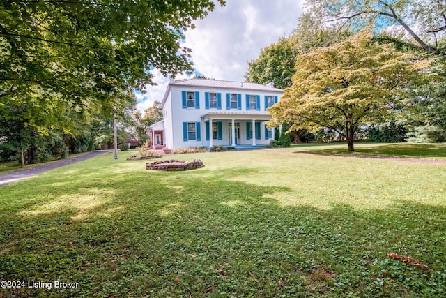4893 N Preston Way, Shepherdsville, KY 40165 - view of front facade with a front yard, a chimney, metal roof, and covered porch