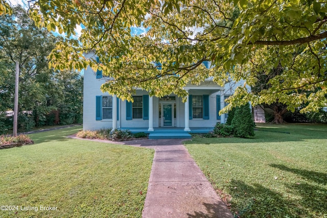 4893 N Preston Way, Shepherdsville, KY 40165 - view of property hidden behind natural elements with a porch, a front yard, and stucco siding