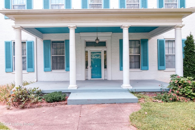 4893 N Preston Way, Shepherdsville, KY 40165 - doorway to property featuring covered porch and brick siding