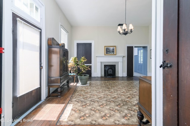 4893 N Preston Way, Shepherdsville, KY 40165 - foyer with a chandelier, wood finished floors, and a fireplace with flush hearth