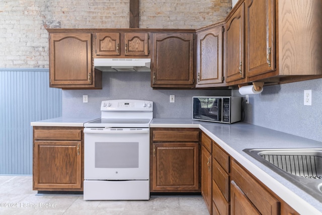 4893 N Preston Way, Shepherdsville, KY 40165 - kitchen featuring under cabinet range hood, white electric range oven, stainless steel microwave, light countertops, and brown cabinets