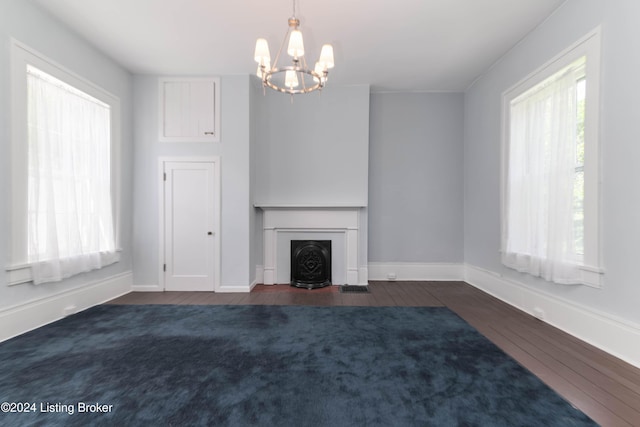 4893 N Preston Way, Shepherdsville, KY 40165 - unfurnished living room featuring dark wood finished floors, a chandelier, baseboards, and a fireplace with flush hearth