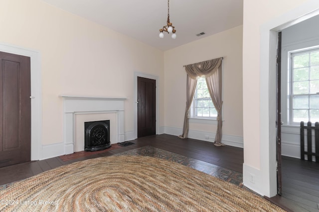 4893 N Preston Way, Shepherdsville, KY 40165 - unfurnished living room with wood-type flooring, plenty of natural light, a chandelier, and a fireplace with flush hearth