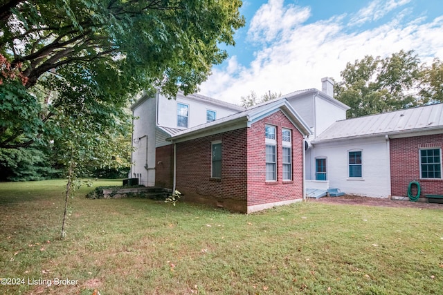 4893 N Preston Way, Shepherdsville, KY 40165 - view of side of home featuring a chimney, a yard, and brick siding