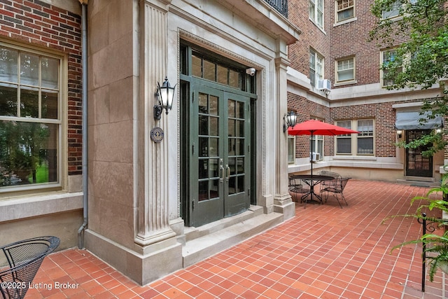 1412 Willow Ave Unit 56, Louisville, KY 40204 - property entrance featuring french doors, brick siding, and cooling unit
